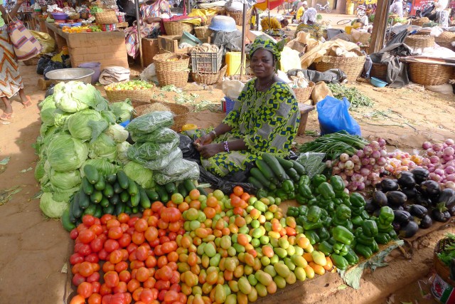 an-outdoor-market-with-people-shopping-and-selling-items