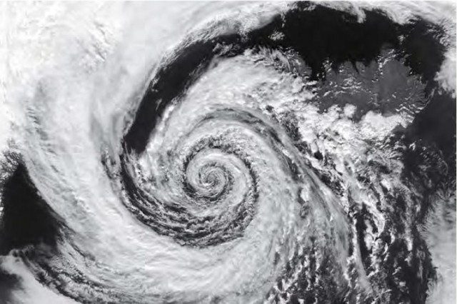 Cyclone in the northern hemisphere, just off Iceland (visible top right). The combination of low pressure and the Coriolis Force brings air towards the centre in an anti-clockwise spiral.